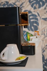 a coffee cup on a table next to a coffee maker at Dolce Vita in Messina