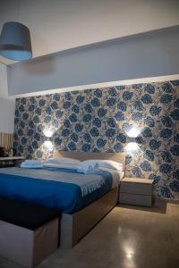 a bedroom with a blue bed with two lights on it at Dolce Vita in Messina +99 photos