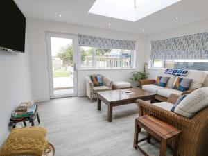 a living room with a couch and a table at Melody in Cemaes Bay
