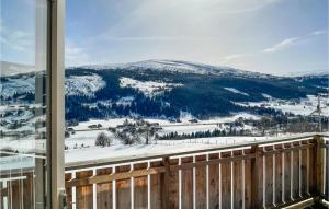 a view of a snowy mountain from a balcony at Awesome Home In len With Wifi And 2 Bedrooms in Ålen