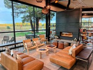 a living room with a couch and a fireplace at Backland in Williams