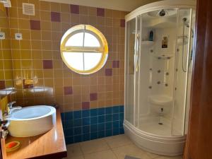 a bathroom with a tub and a sink and a shower at Casa Jasmim in Azeitao +13 photos