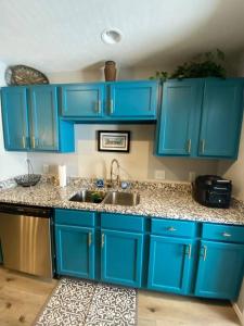 a blue kitchen with a sink and blue cabinets at The Vista in Branson