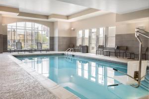 a large pool with blue water in a hotel room at Residence Inn by Marriott Kansas City at The Legends in Kansas City