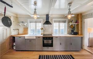 a kitchen with stainless steel cabinets and a stove at Stunning Home In len With Kitchen in Ålen