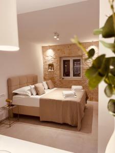 a bedroom with a large bed in a room at Oleander Apartment & Room Centar in Hvar
