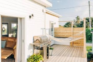 a hammock on the porch of a house at Seahorse Cottage in Indian Harbour