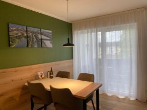 comedor con mesa, sillas y ventana en Livero Apartments, en Sankt Pölten