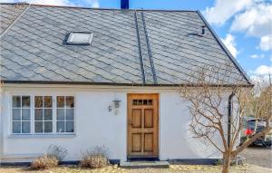 a white house with a wooden door at 3 Bedroom Beautiful Home In Vintrie 