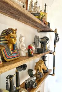 a shelf filled with lots of antique items at על קצה ההר in Yoqne‘am