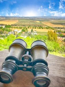 a view of a camera with a view of a field at על קצה ההר in Yoqne‘am