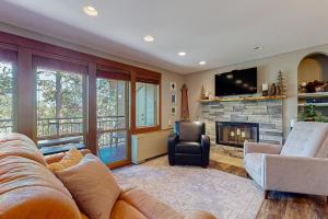 a living room with a couch and a fireplace at Seventh Mountain in Bend