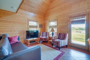 a living room with a couch and two chairs and a television at Lakefront Vacation Rental with Patio and Grill! in Columbia