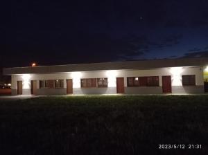 a large white building with lights on it at night at Loft Park Zator in Zator