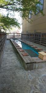 a swimming pool in a building next to a building at Yamanouchi sekisan chi in Yokokura