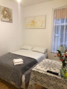 a bedroom with a bed and a table and a window at Double Room Central Location 2 in Plumstead