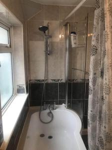a bathroom with a bath tub and a shower at Double Room Central Location 2 in Plumstead