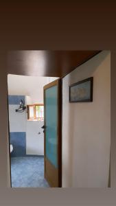 a room with a door to a room with a bathroom at Marko's House in Gjirokastër