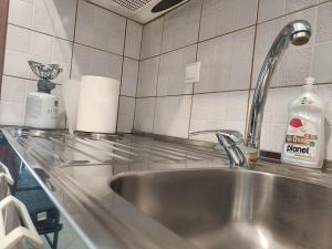 a kitchen counter with a stainless steel sink at Φρίντα στο κέντρο της Ορεστιάδας in Orestiada