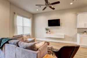 a living room with a couch and a ceiling fan at Youngsville Sports Complex NEW Townhome in Youngsville