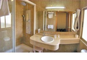 a bathroom with a sink and a shower at Hotel Maria del Mar in Noja +16 photos