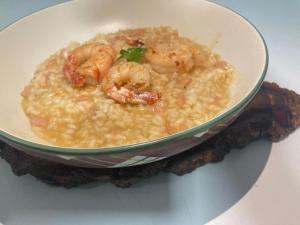 a bowl of food with shrimp on a plate at Hotel Senador Distributed by Ameris in Quedas do Iguacu