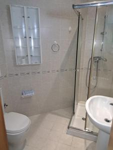 a bathroom with a shower and a toilet and a sink at Holiopolis in St. Paul's Bay