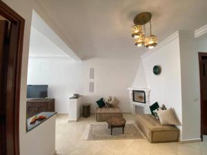 a living room with a couch and a chair at Nice apartment beach front, close to Rabat main sightseeing. Fiber WiFi in Rabat