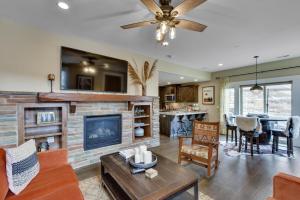 a living room with a fireplace and a dining room at Park City Vacation Rental with Private Hot Tub! in Keetley Junction