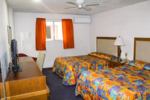 Postel nebo postele na pokoji v ubytování Hotel Paquime
