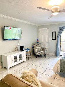 a living room with a flat screen tv on a wall at Ground Floor Convenient Gated Condo At Beach Sawgrass - Pet Friendly!!! in Ponte Vedra Beach