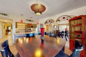 a dining room with a large wooden table and chairs at Tranquil Trail #8 in Carefree