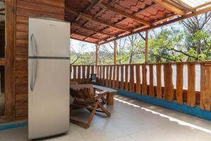 een koelkast op de veranda van een huis bij 1 Bedroom G-Land Burnt Toast Surfcamp in Nosara