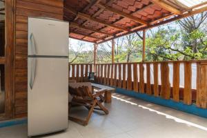 a refrigerator on the porch of a house at 1 Bedroom G-Land Burnt Toast Surfcamp in Nosara