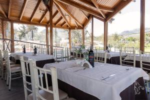 a dining room with tables and chairs in a building at Chaupimundo Lodge in Quito