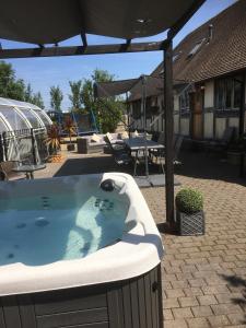 a hot tub in a patio with a table and chairs at Fletchers Hall in Freckleton