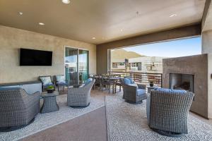 a living room with chairs and a table and a television at Scottsdale Scenery in Scottsdale