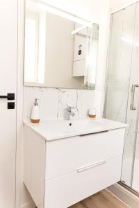 une salle de bain blanche avec lavabo et douche dans l'établissement Le naturel - Superbe logement - Extérieur privatif - Centre ville, au Mans