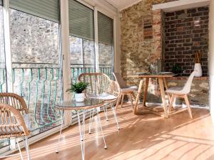 une terrasse couverte avec des chaises et des tables ainsi qu'une grande fenêtre dans l'établissement Le naturel - Superbe logement - Extérieur privatif - Centre ville, au Mans 16 autres photos