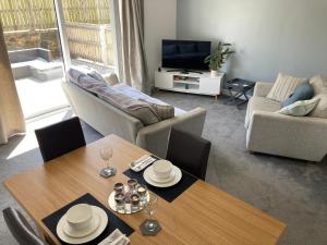 a living room with a table and a couch at Cozy & Spacious home In the heart of Snowdonia in Llanddeiniolen