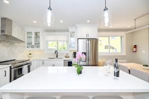 a kitchen with white cabinets and a white counter top at The Newark House in Niagara on the Lake