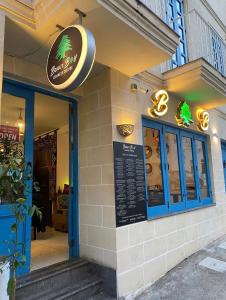 a restaurant with a sign on the front of it at The Exiles Hotel in Sliema