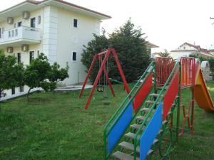 a row of playground equipment in a yard at Kourtis in Paramythia