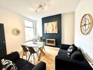 a living room with a table and a dining room at Princes Park semi with Jacuzzi sleeps 6 L8 in Liverpool