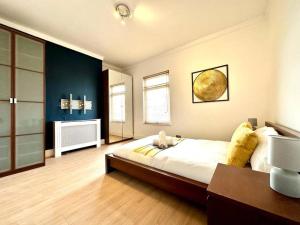 a large bedroom with a large bed and a desk at Princes Park semi with Jacuzzi sleeps 6 L8 in Liverpool