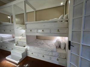 a bedroom with two bunk beds with white furniture at Paris east in Cairo +214 photos