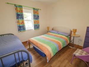 a bedroom with a bed and a window at Creeslough View in Creeslough