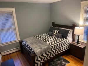 a bedroom with a bed with a zebra print blanket at A new Renovated cozy three Bedrooms APT in Pawtucket
