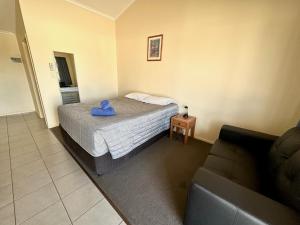 1 dormitorio pequeño con 1 cama y 1 sofá en Moura Motel en Moura