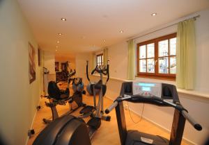 a gym with several exercise bikes in a room at Hotel Gasthof Waldschenke in Marlengo